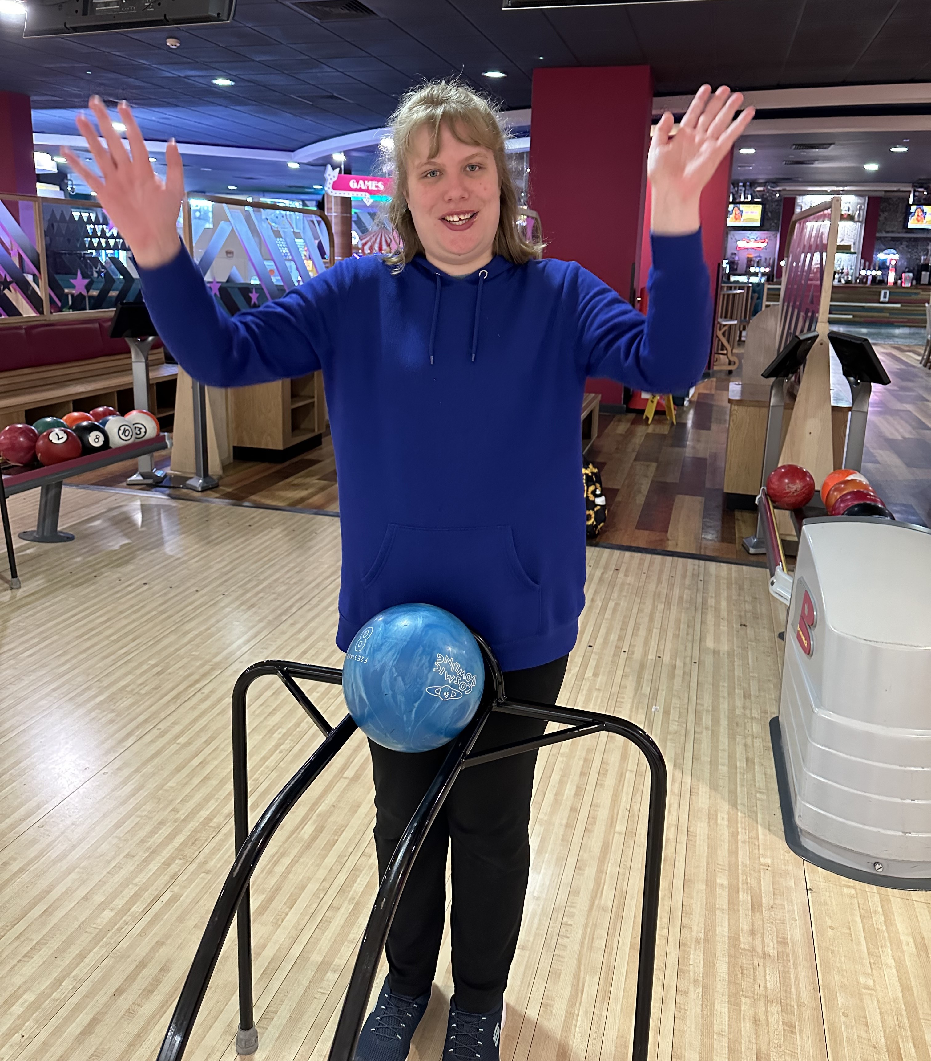 April waving while bowling