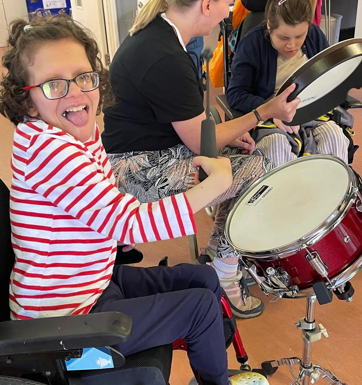 Lauren playing drums in music therapy