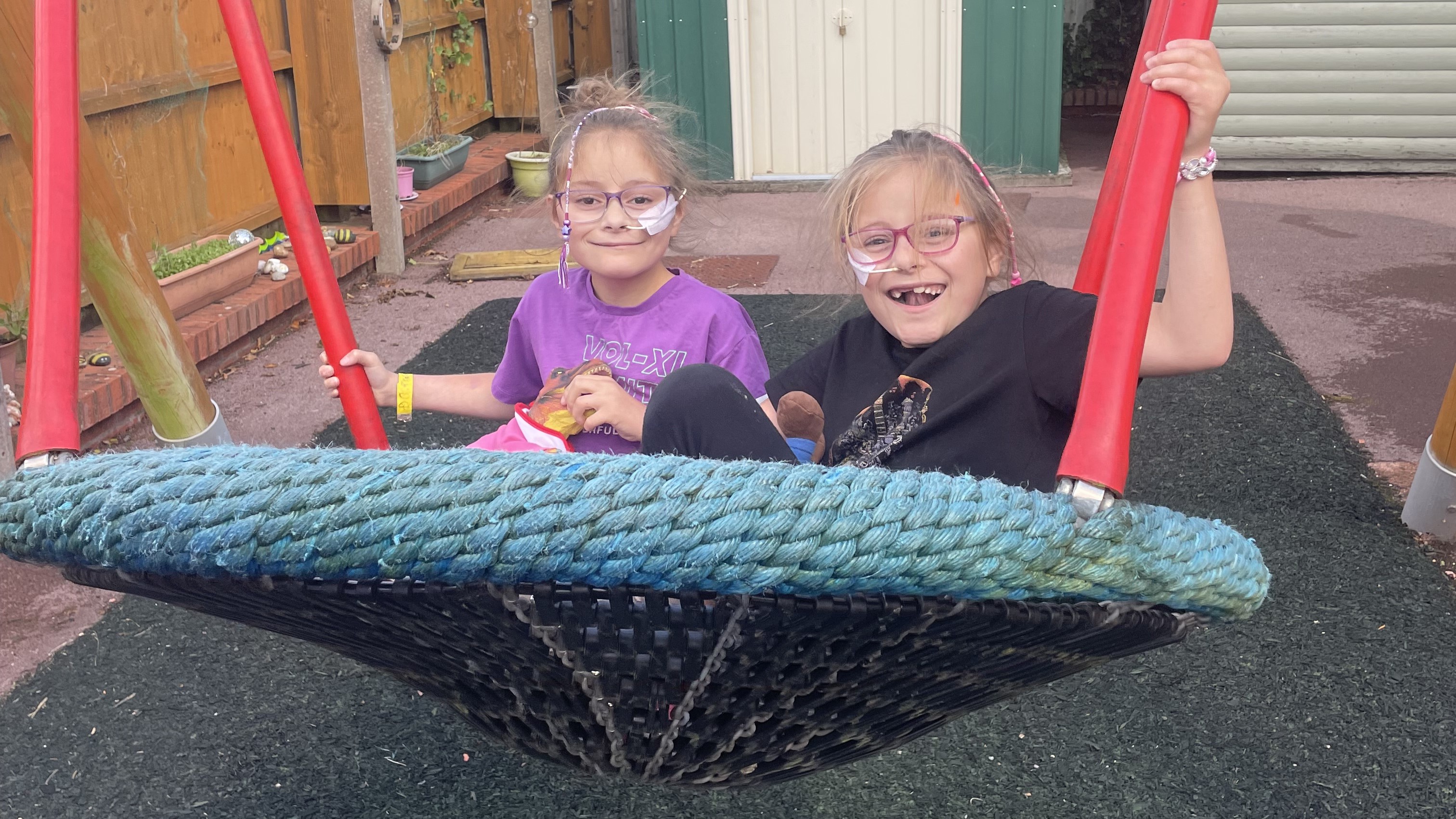 Darcey and Eden on a large swing